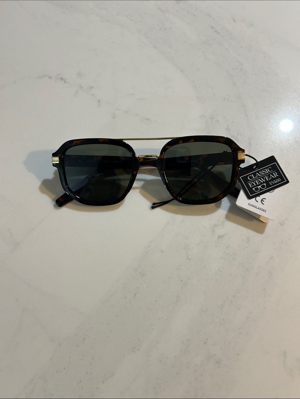 Classic Eyewear Tortoiseshell Sunglasses with Green Lenses